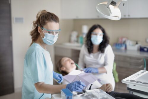 female-dentist-treating-her-patient-3881325